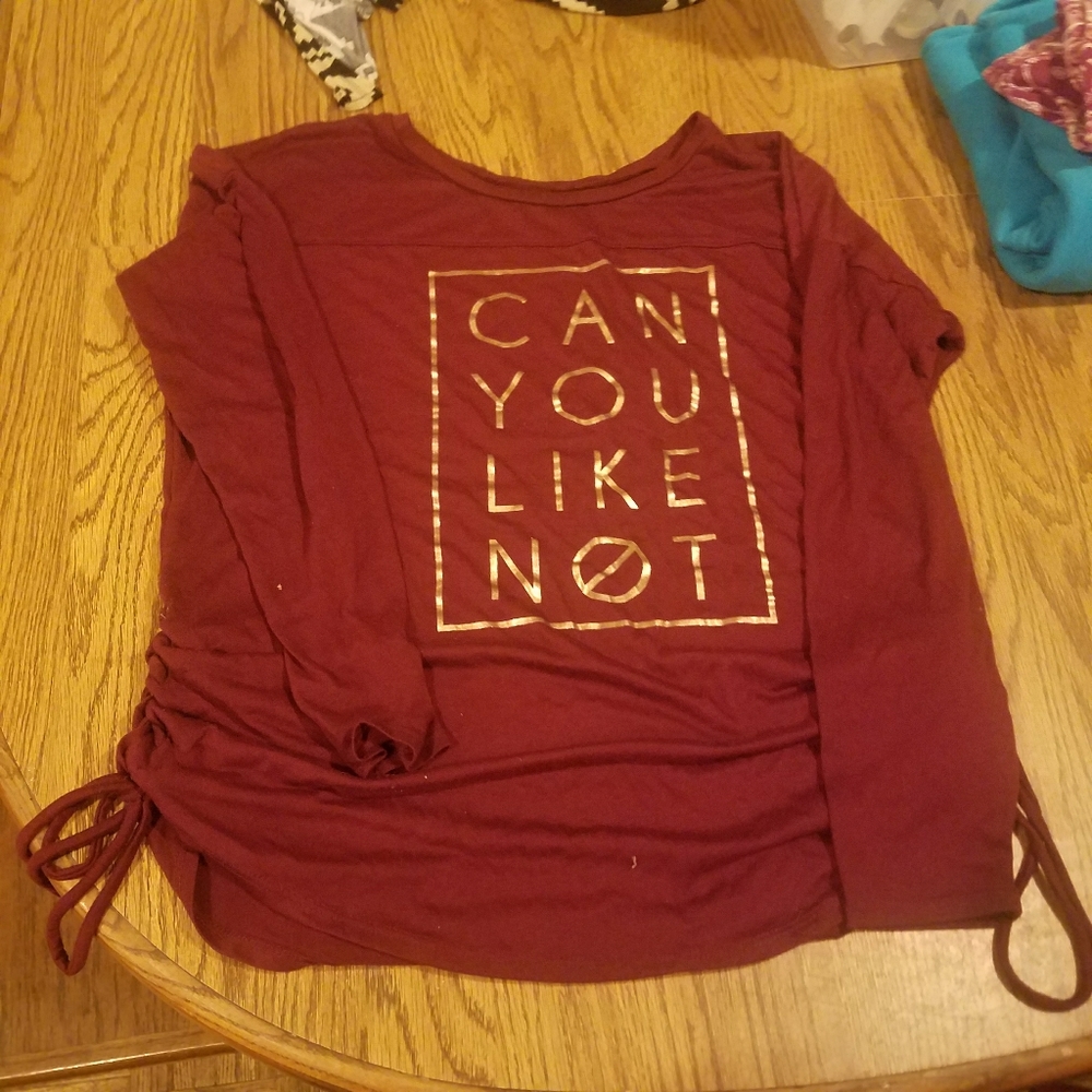 Red shirt with gold lettering braided on sides